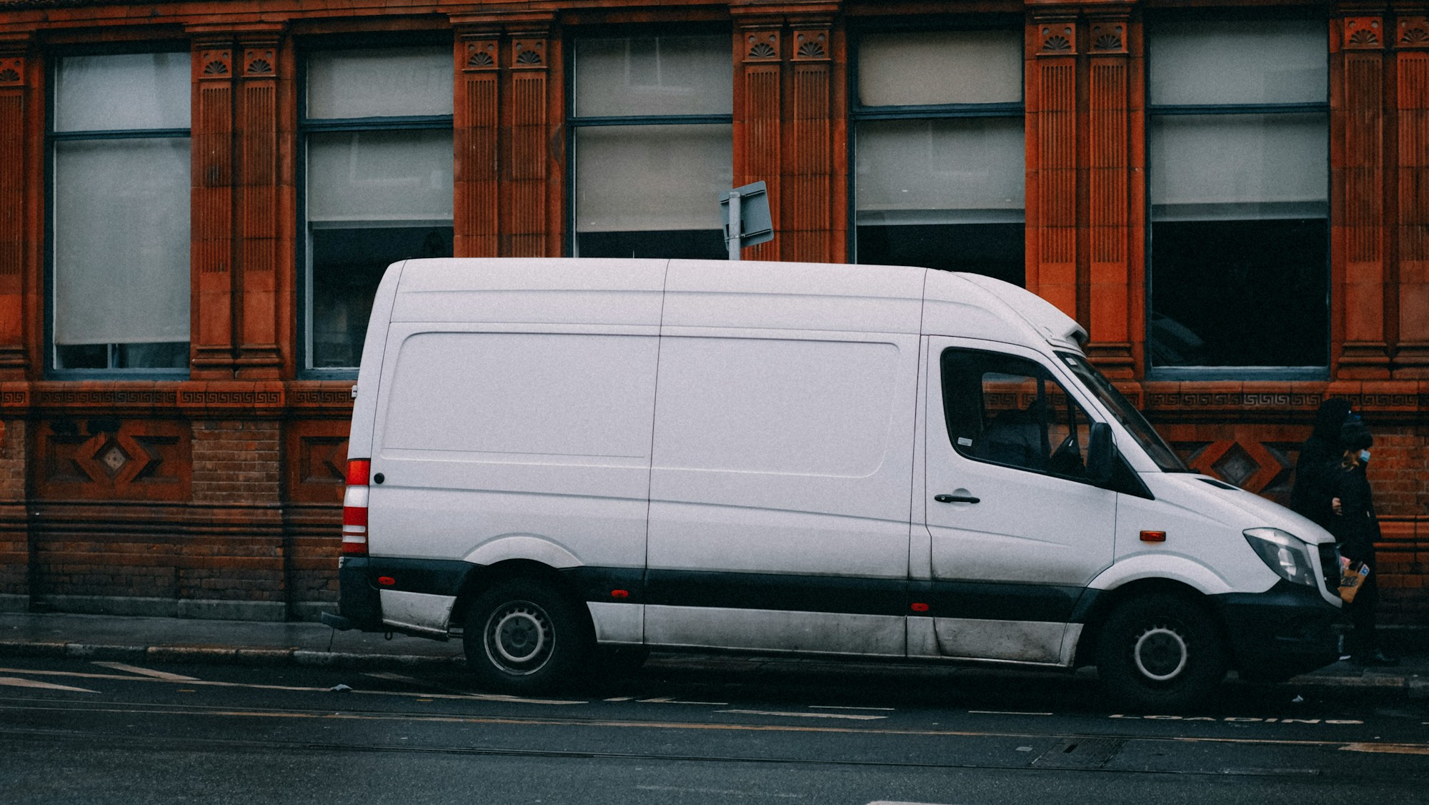 White delivery van parked on a city street